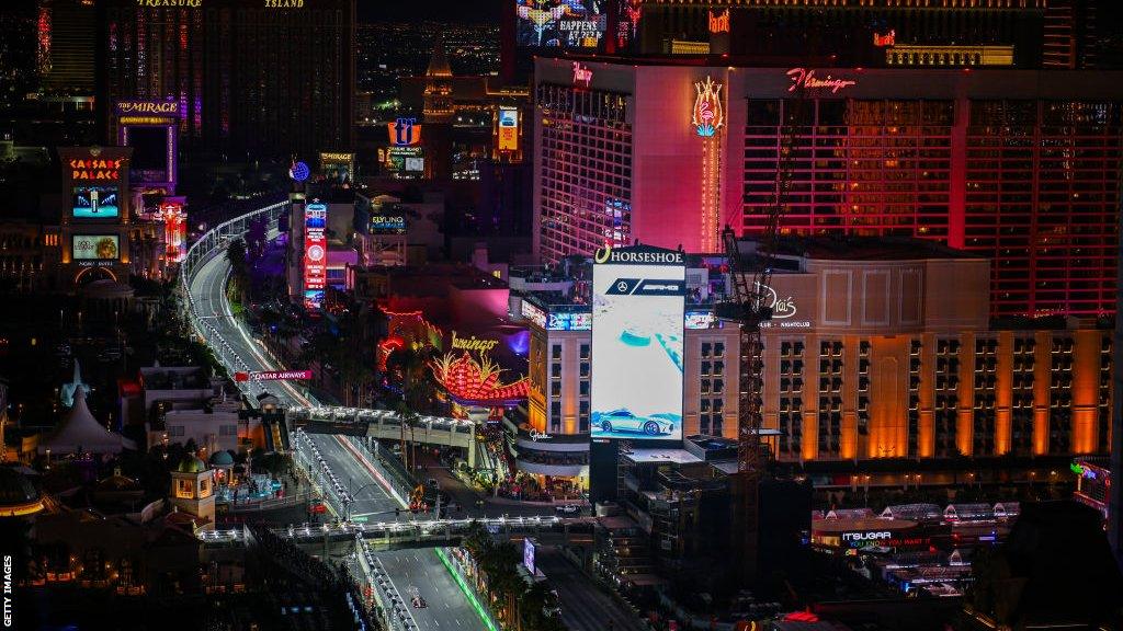 an image of the Las Vegas strip as Max Verstappen drives a lap during practice