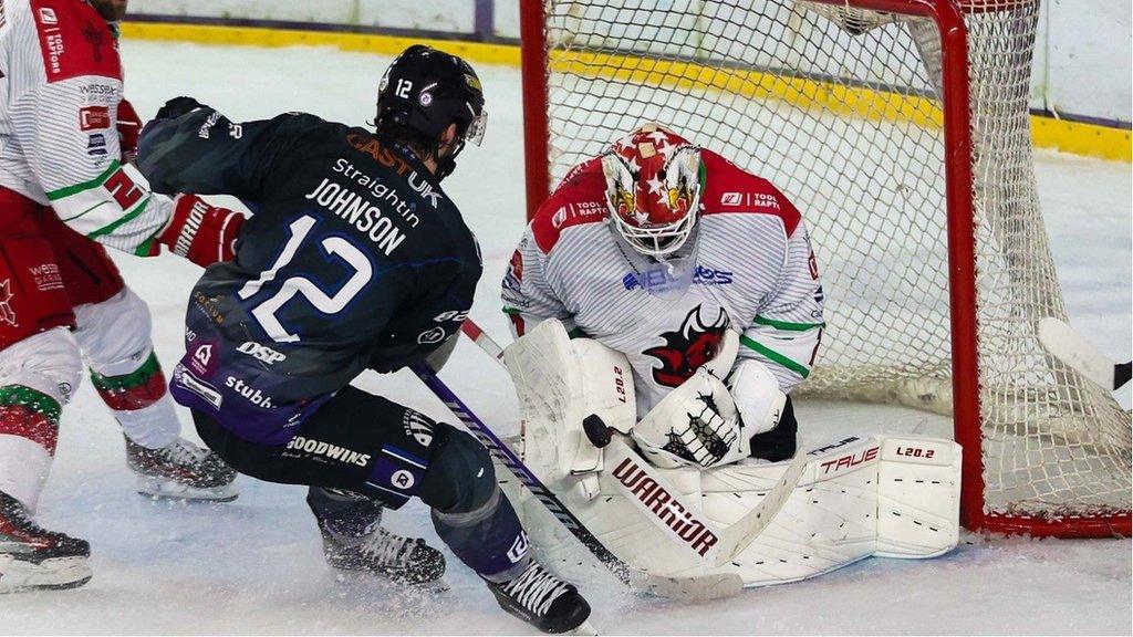 Cardiff Devils netminder Tyler Walls saves against Manchester Storm's Stephen Johnson