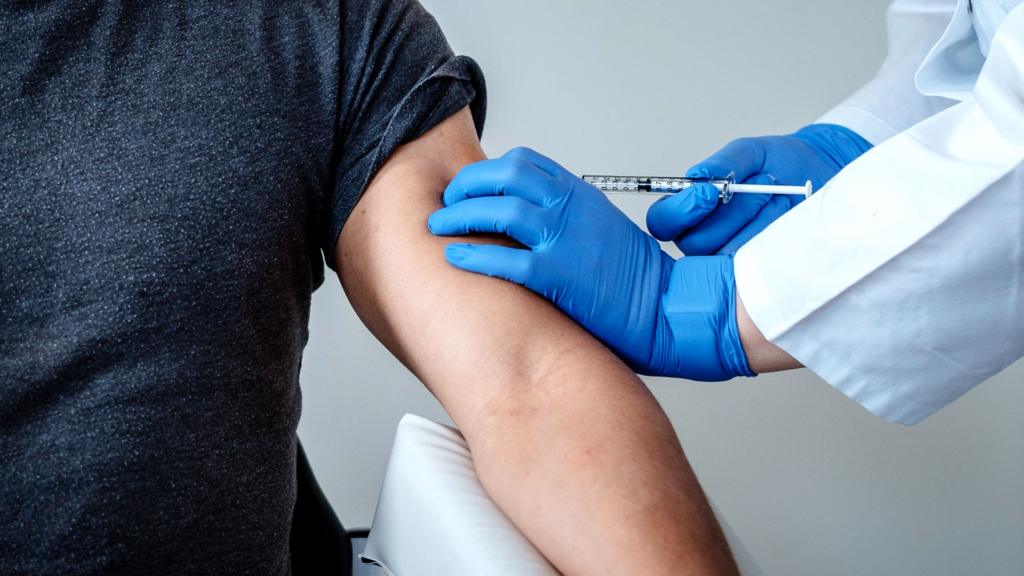 Close-up of a volunteer being injected with trial vaccine - BNT162