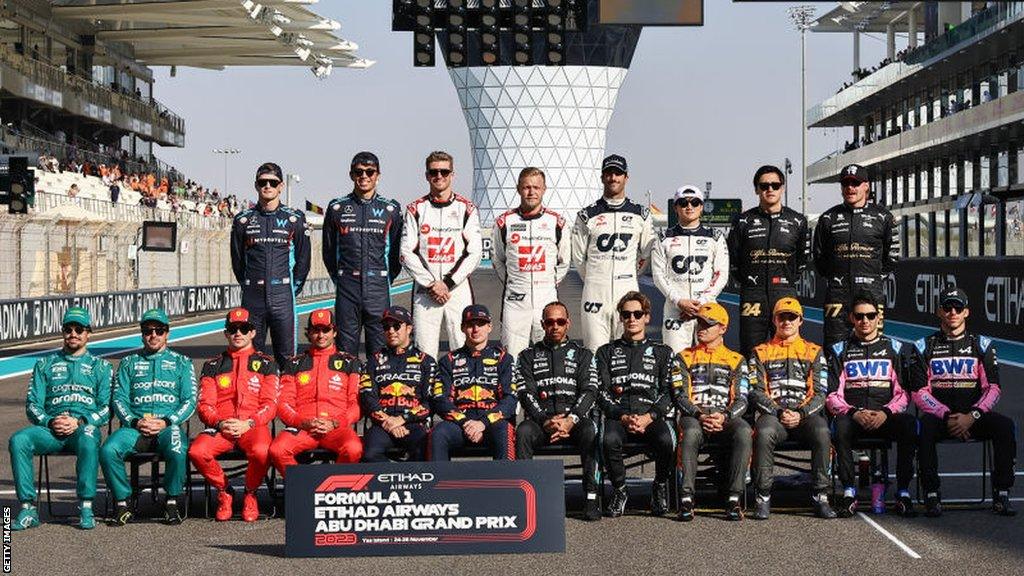 all 20 drivers line up for a picture after the 2023 season