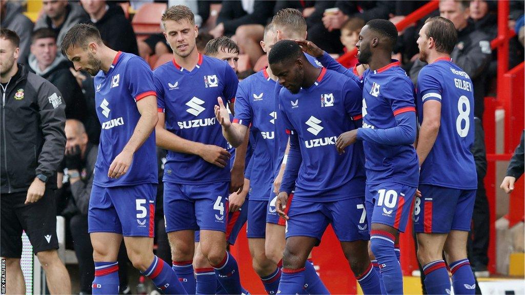 MK Dons players celebrate Jonaathan Leko's goal