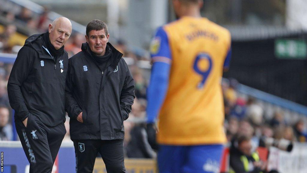 Mansfield Town boss Nigel Clough (right) talks to his assistant during a game