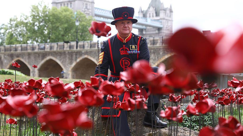 Yeoman Sergeant Dan Benson amongst a new display of ceramic poppies, called The Tower Remembers