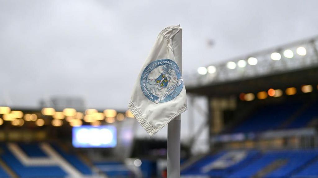 A corner flag with Peterborough United's crest on it.