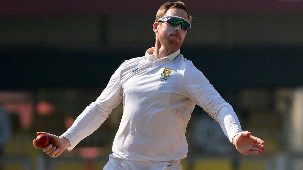 South Africa's Simon Harmer bowls during the fifth day of the second Test cricket match between India and South Africa at the Barsapara Cricket Stadium in Guwahati on November 26, 2025.