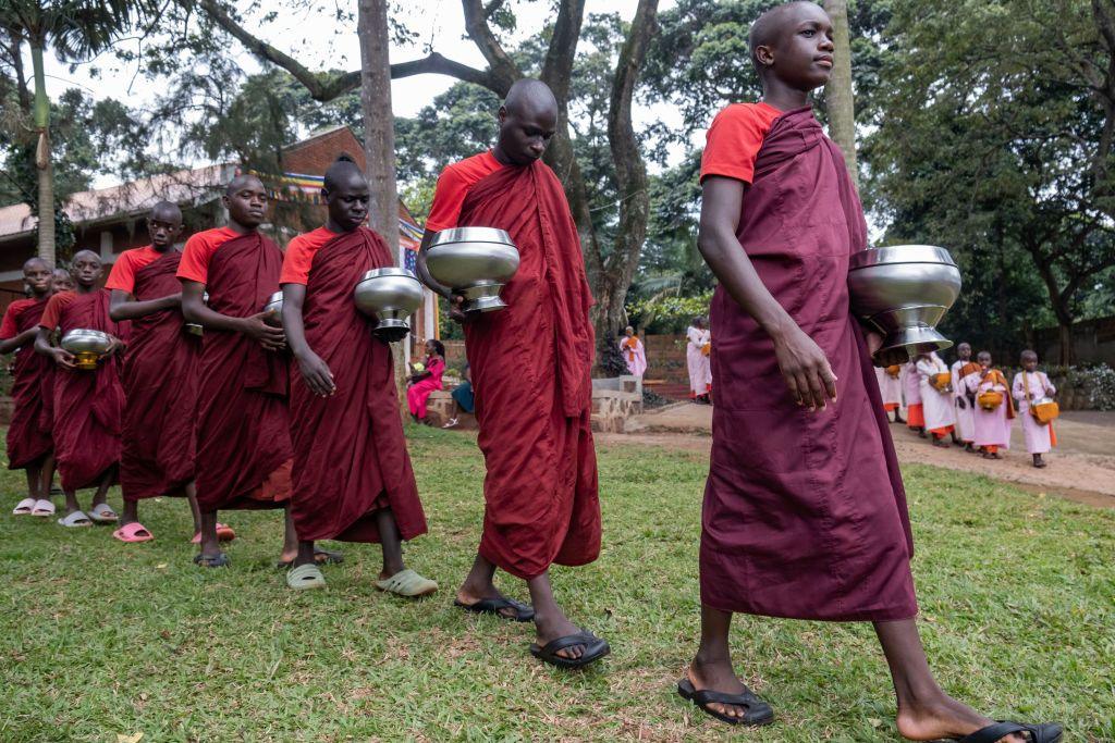 Ugandan novice monks dressed in shades of red and brown are queuing up to receive an offering from the community after meditation celebrating Kathina, a significant event on the Buddhist calendar in Entebbe, on 20 October. Bhante Buddharakkhita, formerly known as Steven Jemba Kabogozza, brought Buddhism to Uganda 20 years ago after returning from India. Since 2005, he has been teaching mindfulness meditation across Africa. His ambitious goal is to train at least 54 monks and send each one to a different African country to teach and spread the message of Buddhism within the context of the African culture.