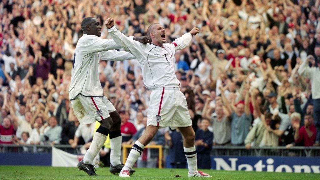 David Beckham (with Emile Heskey) celebrates his free-kick against Greece in 2001