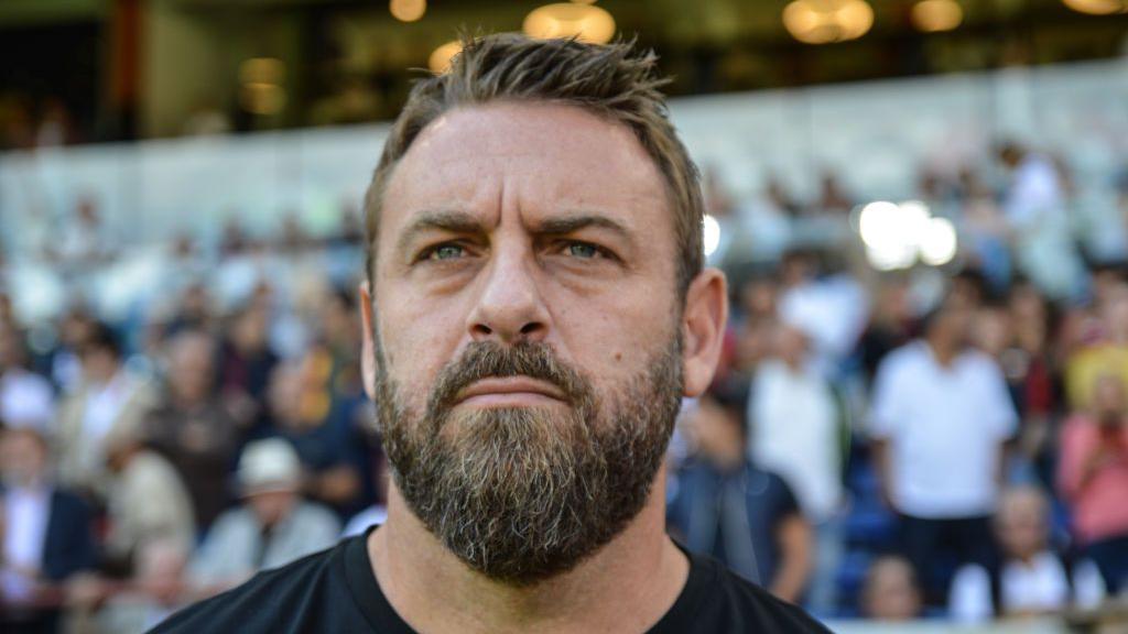 Daniele de Rossi shown close-up with onlookers in stand behind him