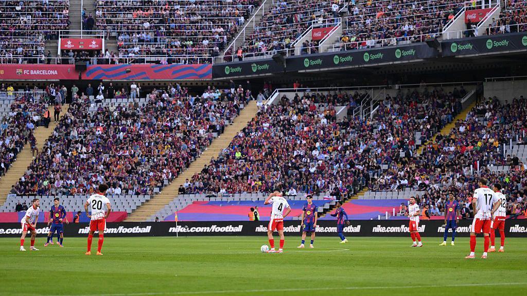 The players of Barcelona and Girona stand still for 15 seconds after kick-off during their La Liga fixture