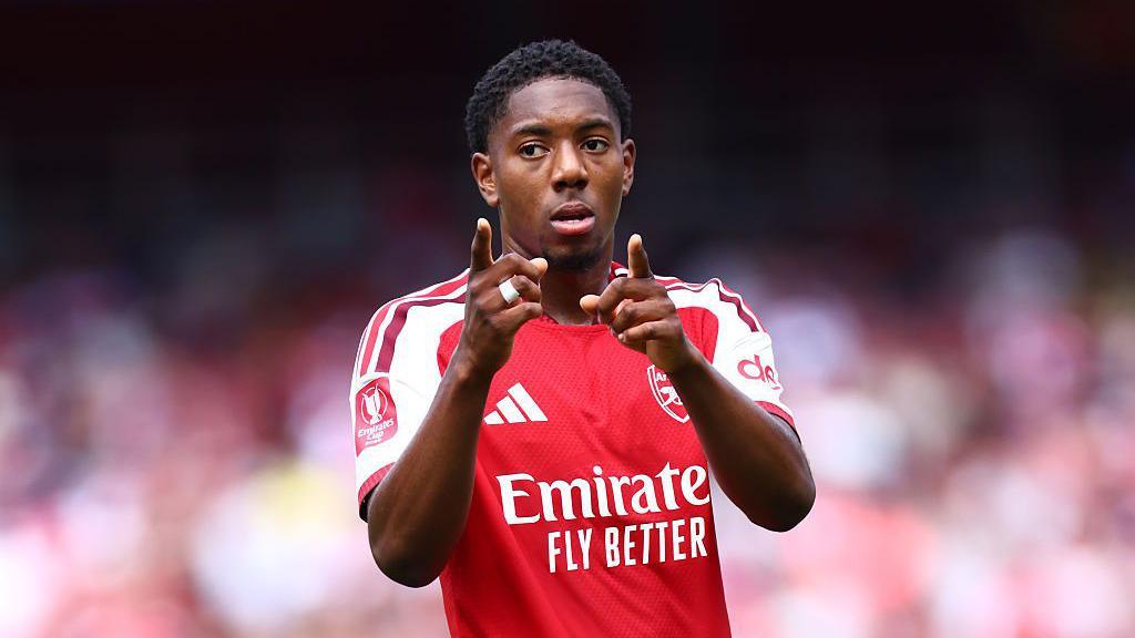 Myles Lewis-Skelly of Arsenal points at the camera