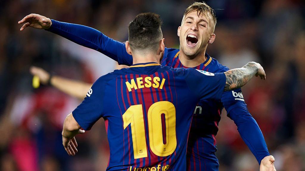 Gerard Deulofeu hugs Lionel Messi