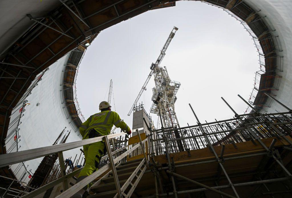 Construction worker walking up stairs at Hinkley Point C nuclear plant.