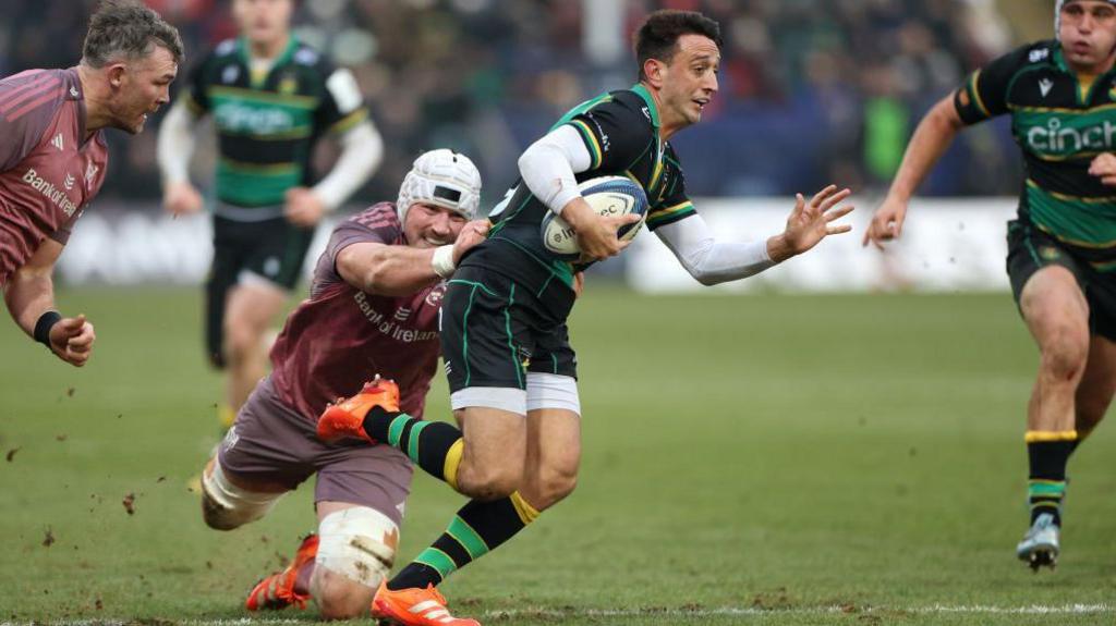  Alex Mitchell is tackled by Munster's Fineen Wycherley 