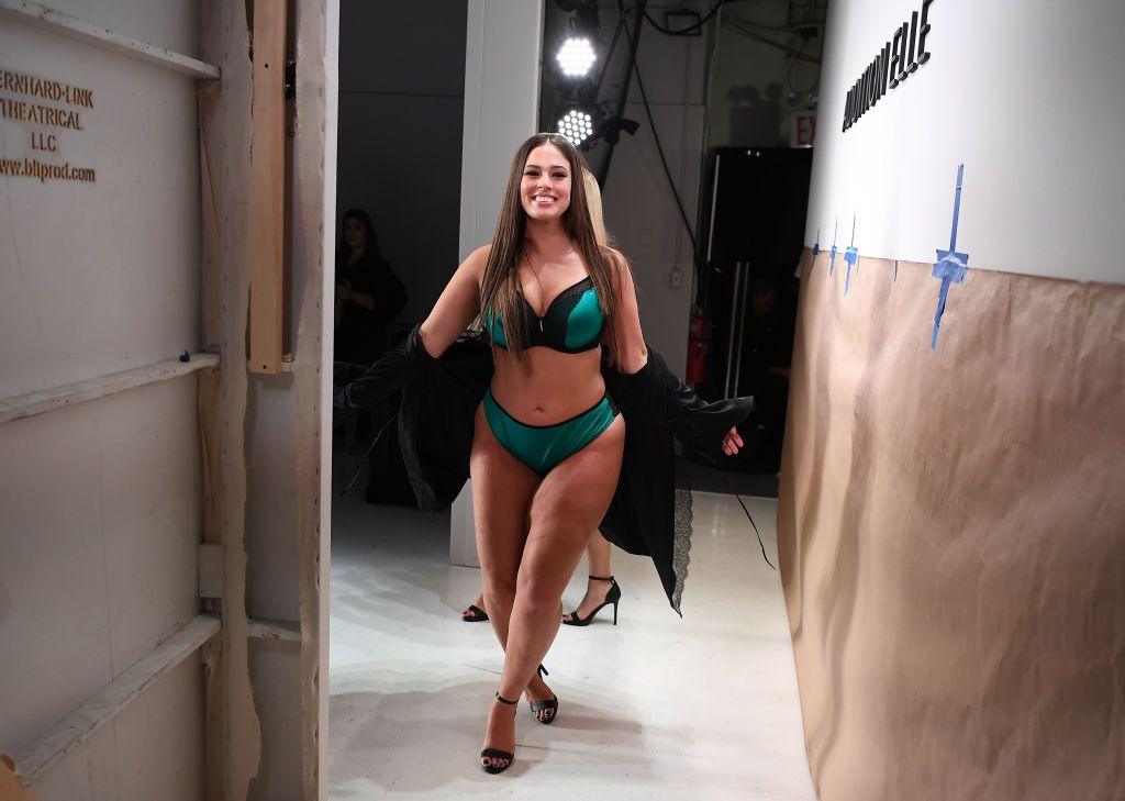 Model Ashley Graham wearing green underwear walks on a runway during New York fashion week