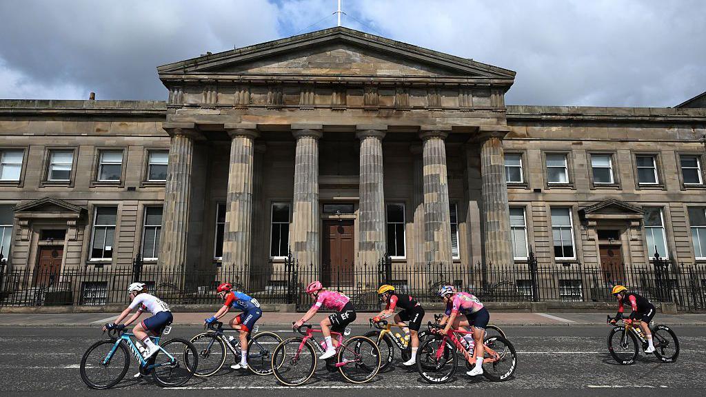 Cyclists race past the High Court in Glasgow