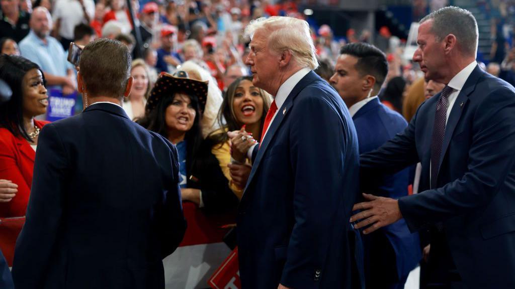 Donald Trump surrounded by his US Secret Service detail at an August rally in Atlanta, Georgia.