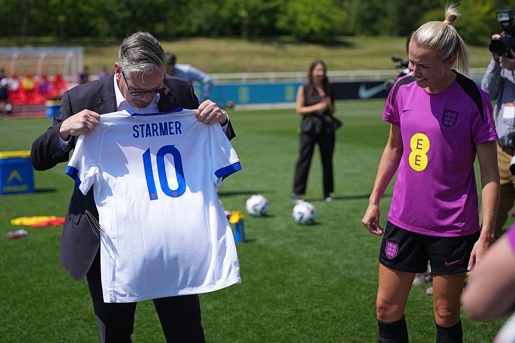 UK Prime Minister Keir Starmer is presented with a personalised England shirt from player Leah Williamson