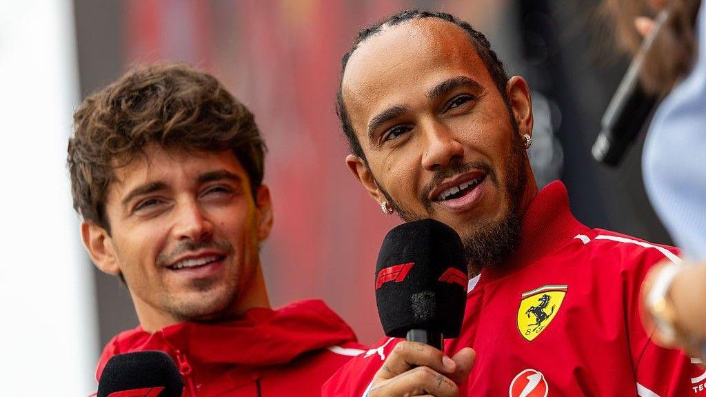 Ferrari drivers Charles Leclerc and Lewis Hamilton pictured holding microphones at the Sao Paulo Grand Prix
