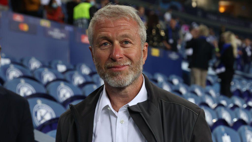 Roman Abramovich wearing a white shirt and black jacket