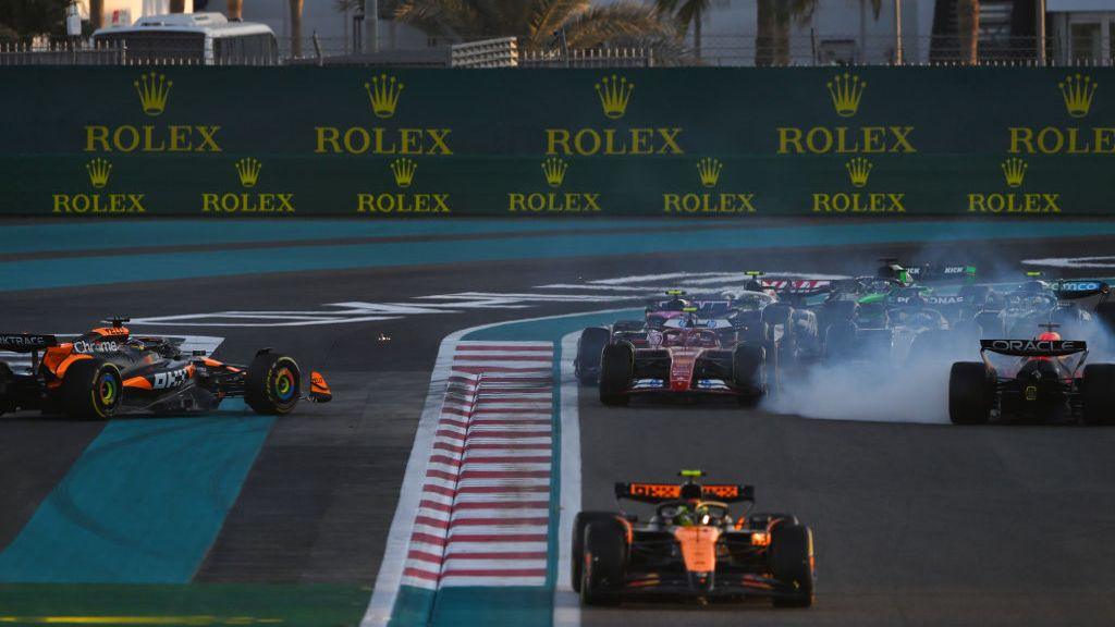 Red Bull's Max Verstappen and McLaren's Oscar Piastri facing the wrong way after colliding at the first corner