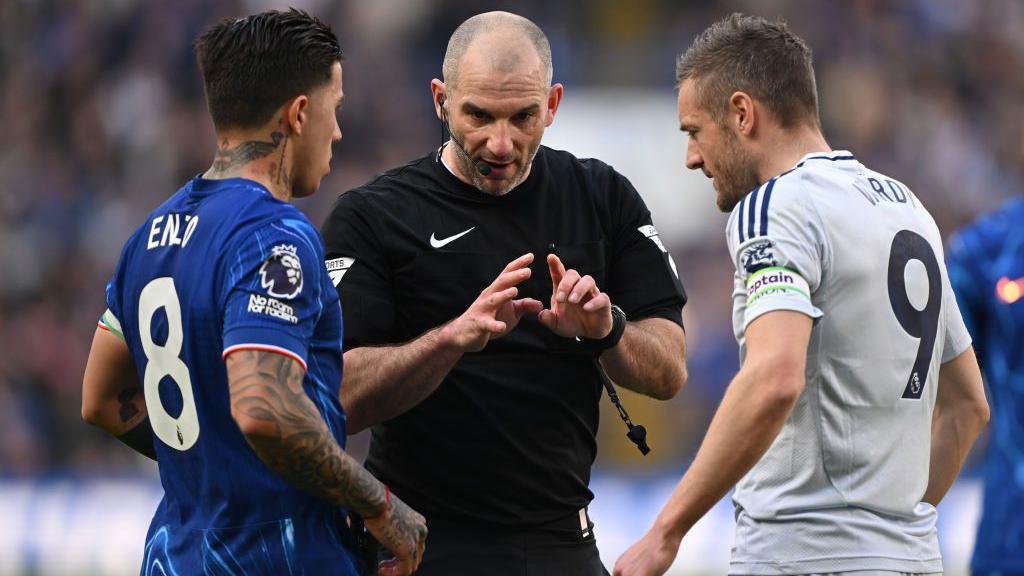 Referee with two players
