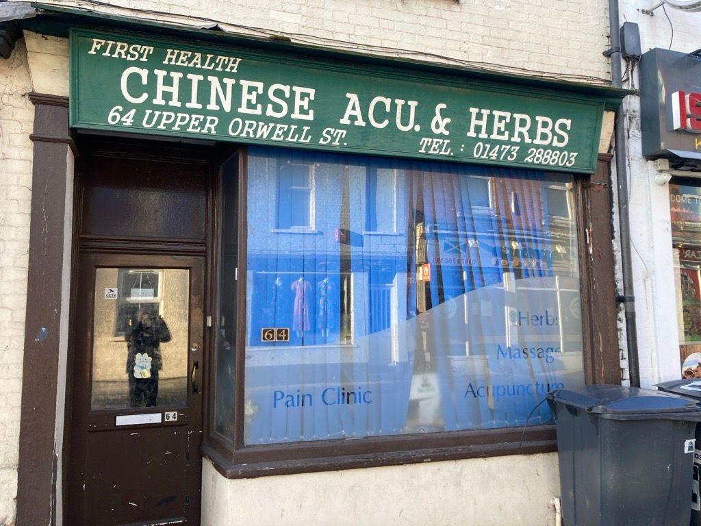 A shop front, showing the branding "first health, Chinese ACU. & Herbs" and the address 64 Upper Orwell Street.