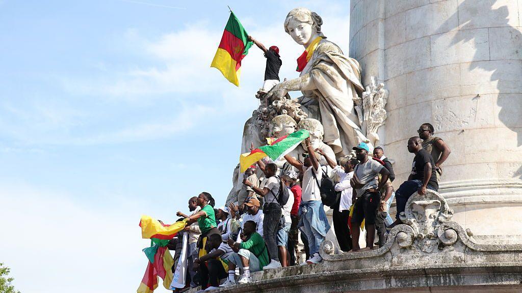 Protesters gather at Place de la Republique in Paris on May 31, 2025, at the call of the Cameroonian diaspora. Waving flags, holding placards and banners, they expressed their opposition to President Paul Biya,