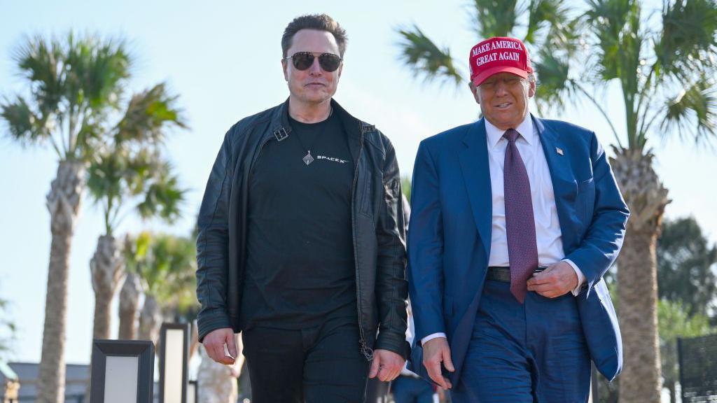 Elon Musk and Donald Trump walking side-by-side