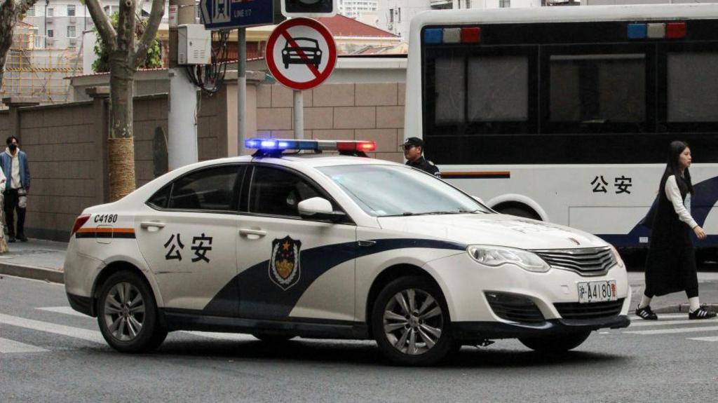 A police car on a road in Shanghai, China in November 2023