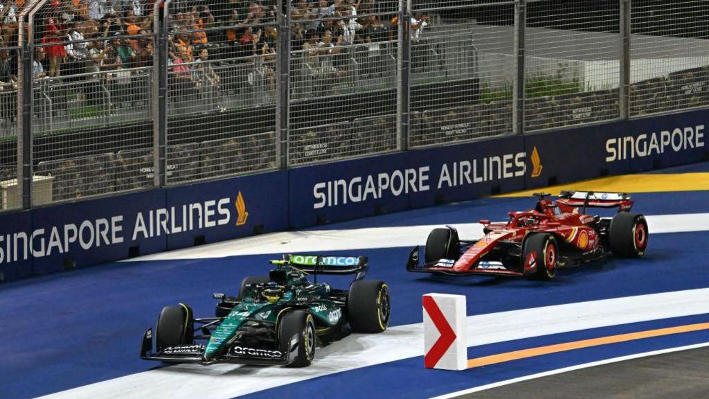 Aston Martin's Fernando Alonso and Ferrari's Charles Leclerc return to the track on the first lap of the Singapore Grand Prix