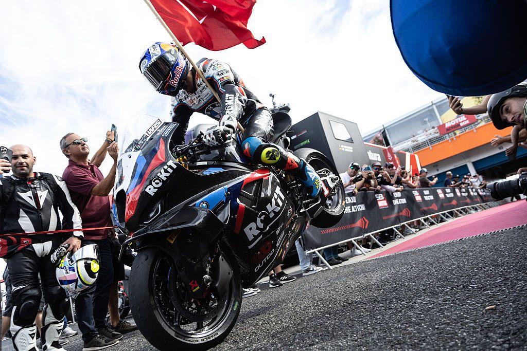 Toprak Razgatlioglu performs a 'stoppie' to celebrate winning the superpole race at the World Superbikes Estoril in Portugal