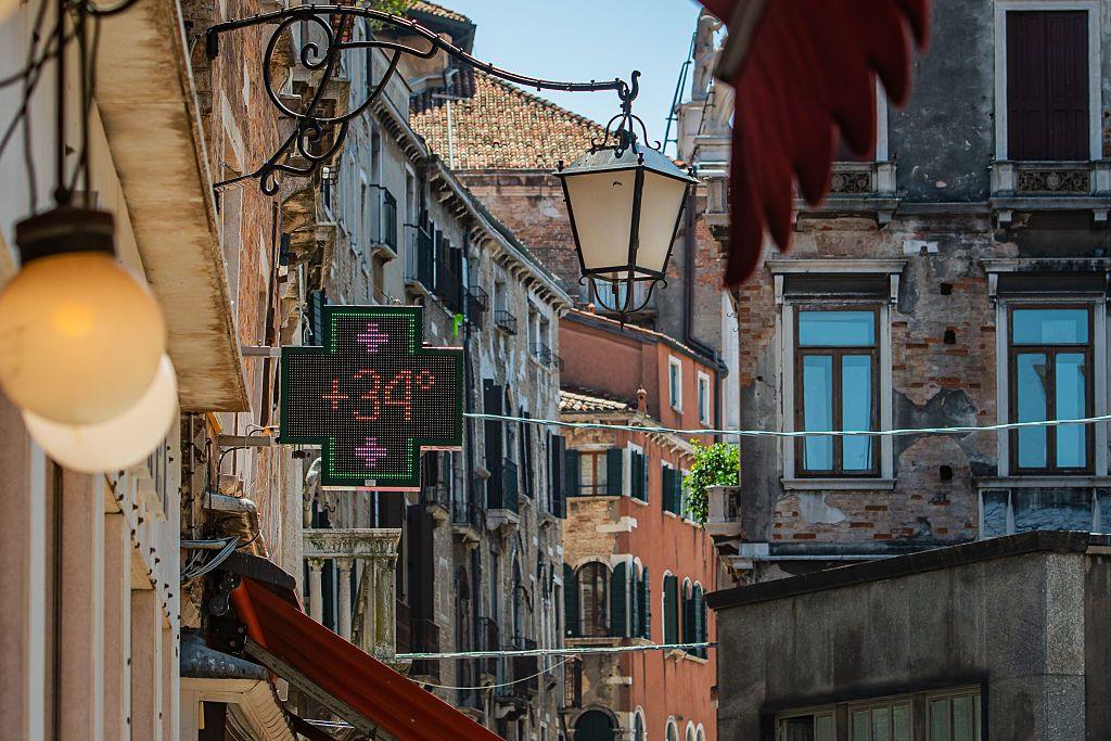 A pharmacy sign in Venice shows the temperature is 34C