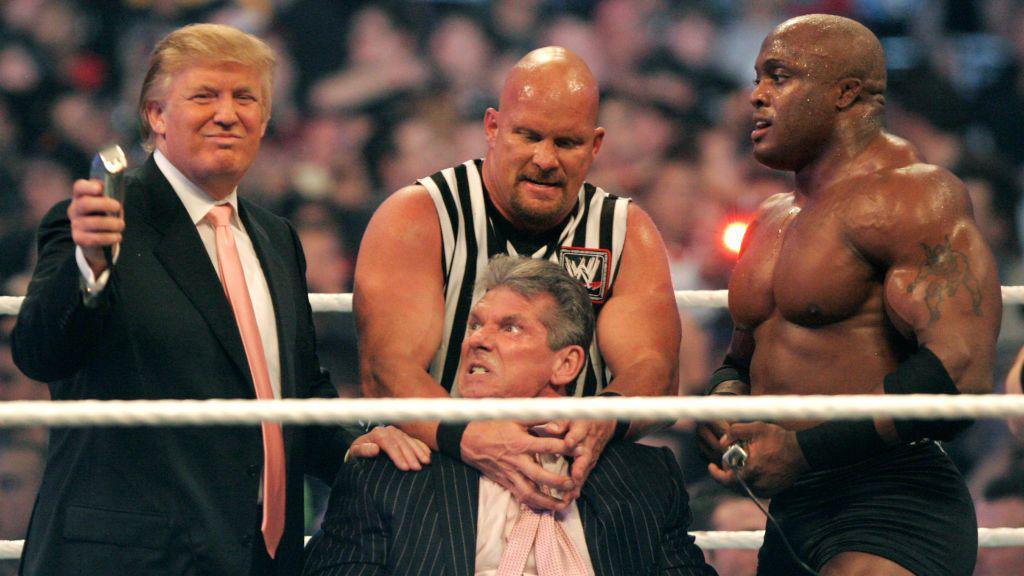 Donald Trump, in suit and tie, shows off a trimmer as Stone Cold Steve Austin, in a sleeveless referee shirt, restrains an irate Vince McMahon