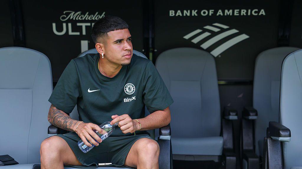 Chelsea midfielder Kendry Paez sits on the substitute bench in training wear