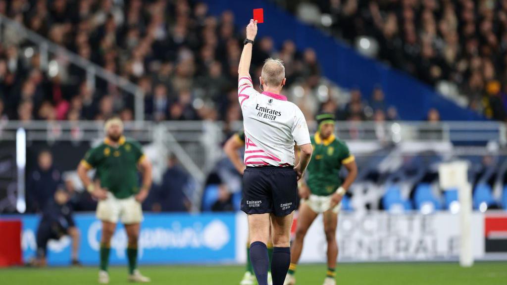 Wayne Barnes shows a red card to Sam Cane