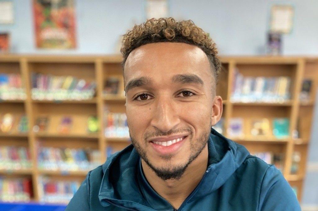 Luton Town forward Jacob Brown at a school library after speaking to pupils about tackling discrimination in sport.