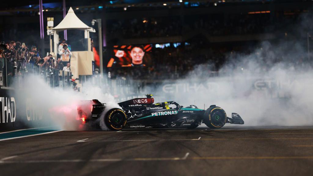 Lewis Hamilton doing donuts on track after his final race with Mercedes