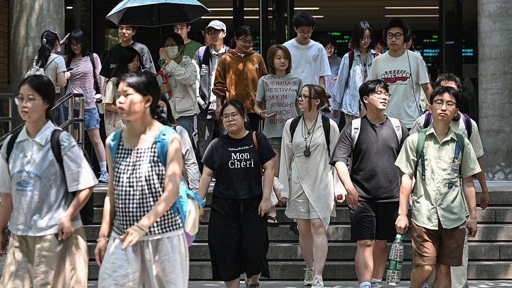 Students walk out of a building at the Beijing Foreign Studies University in 29 May, 2025