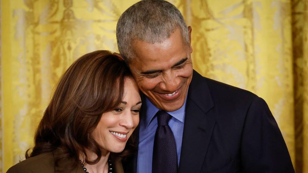 Barack Obama and Kamala Harris smile together at a White House event in 2022 to mark the anniversary of the signing of the Affordable Care Act.