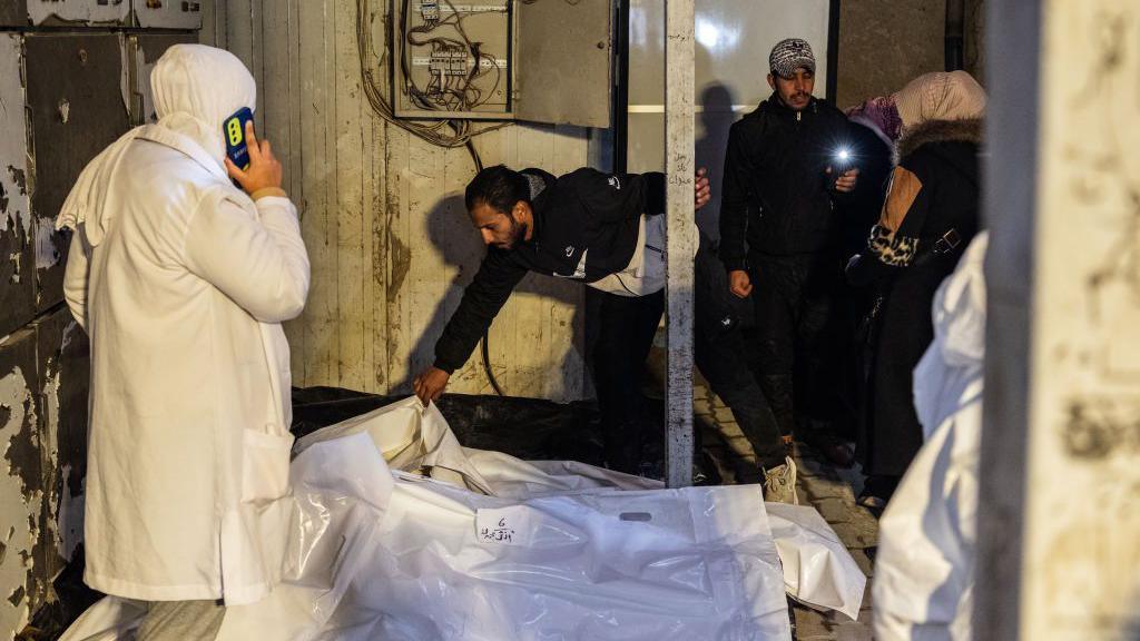 People searching for missing family members gather outside at Al Mujtahid Hospital to identify bodies who were tortured to death by the Assad regime in Damascus, Syria on December 11, 2024