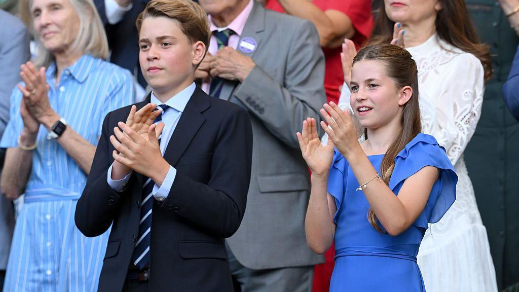 Prince George of Wales and Princess Charlotte of Wales clap as they attend day fourteen of the 2026 Wimbledon Tennis Championships.