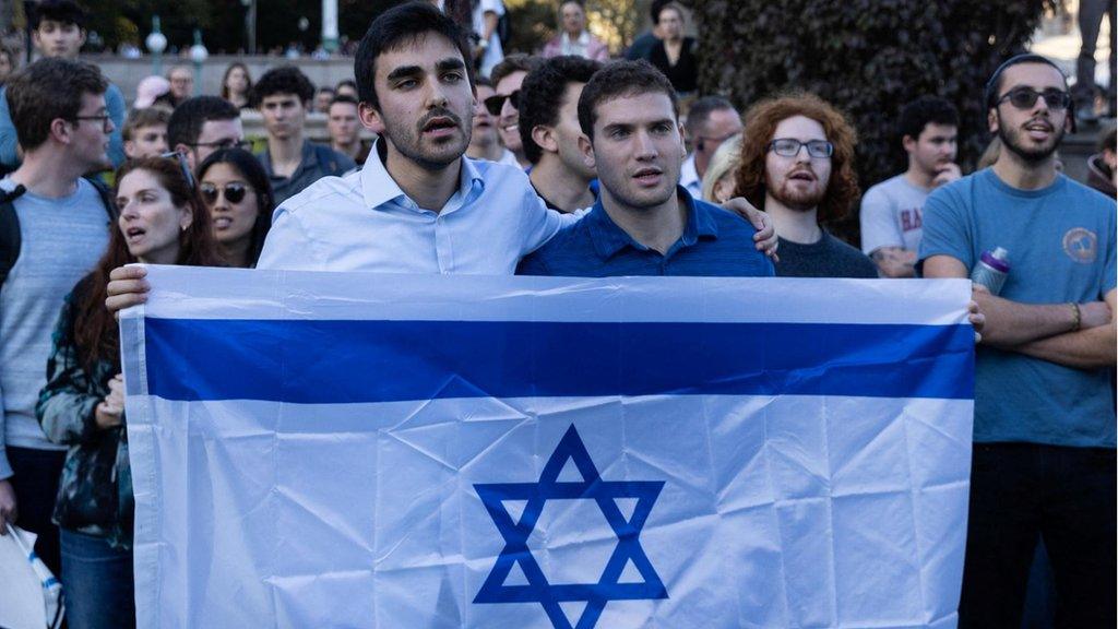 Two men hold an Israeli flag in New York