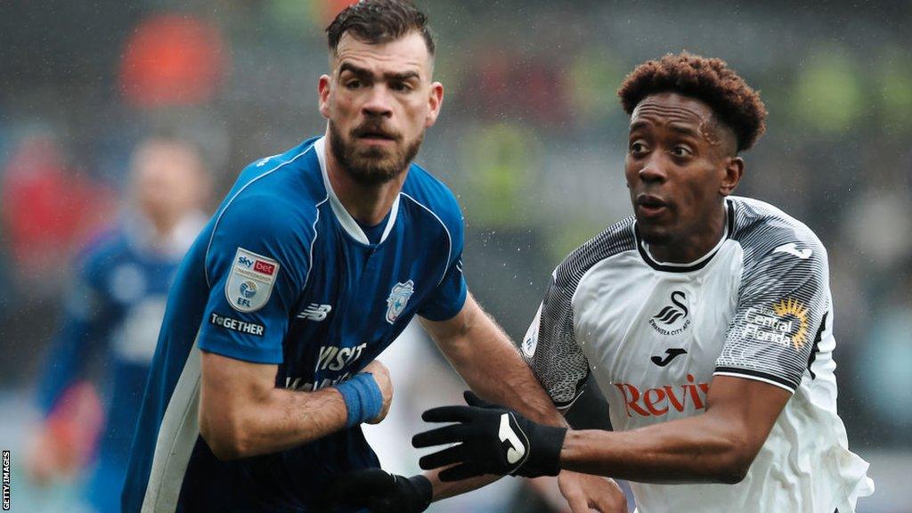 Cardiff defender Dimitrios Goutas battles Swansea forward Jamal Lowe