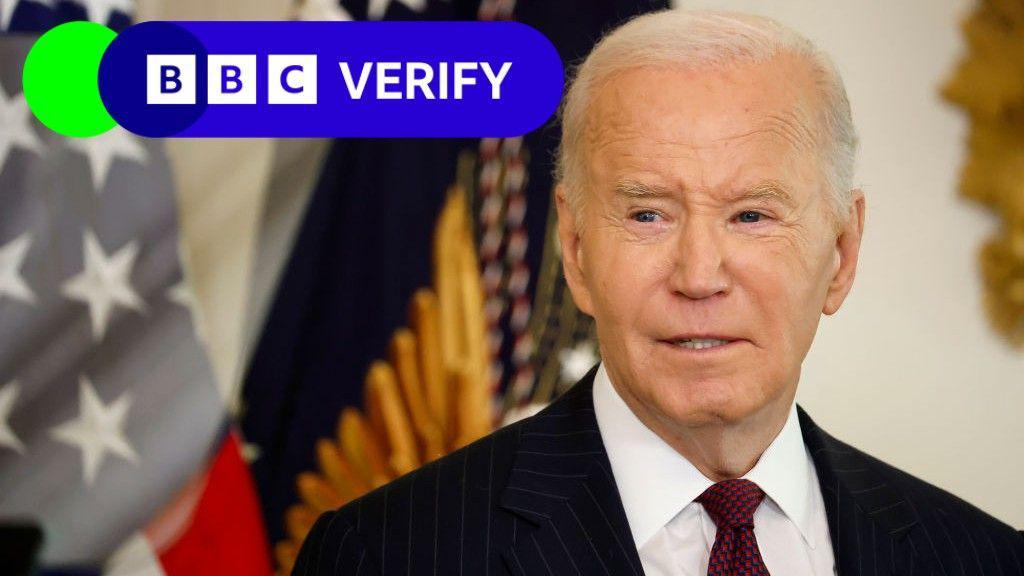 Joe Biden speaks to reporters in the White House. An American flag is visible in the background, and the BBC Verify logo has been imposed over the image. 