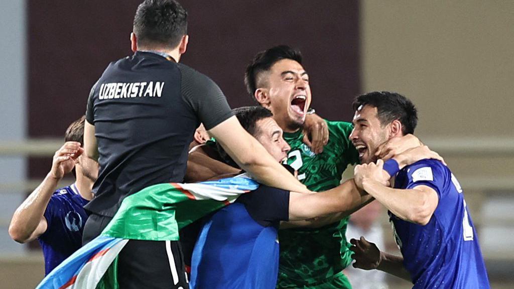 Uzbekistan players celebrate qualifying for the World Cup