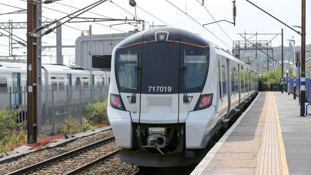 A Great Northern train at Horley station with another one in the depot behind