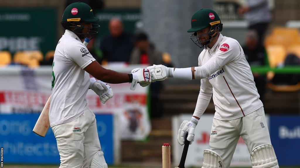 Rishi Patel (left) and Peter Handscombe (right) touch gloves after reaching lunch against Sussex