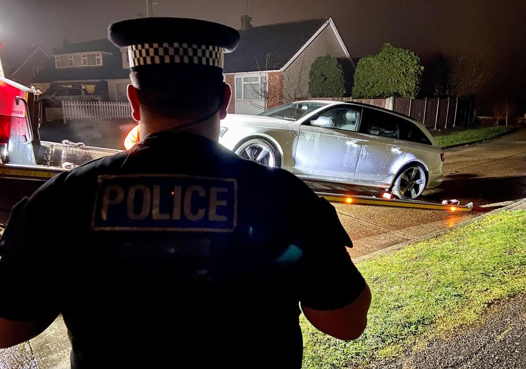 A police officer by a car