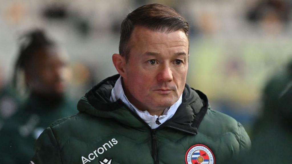 Reading boss Noel Hunt looks on.