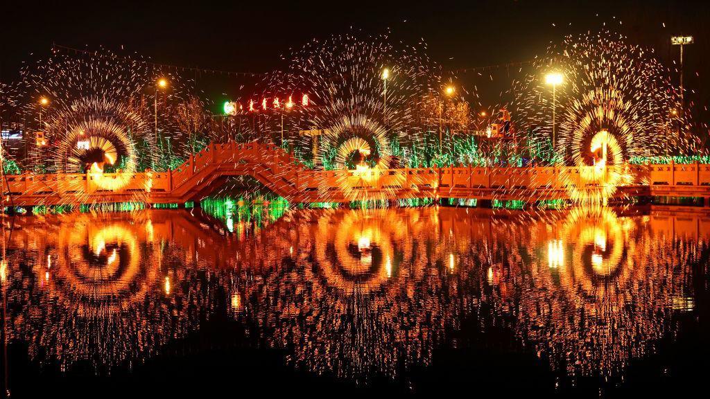 artists waving special fireworks in spirals in china